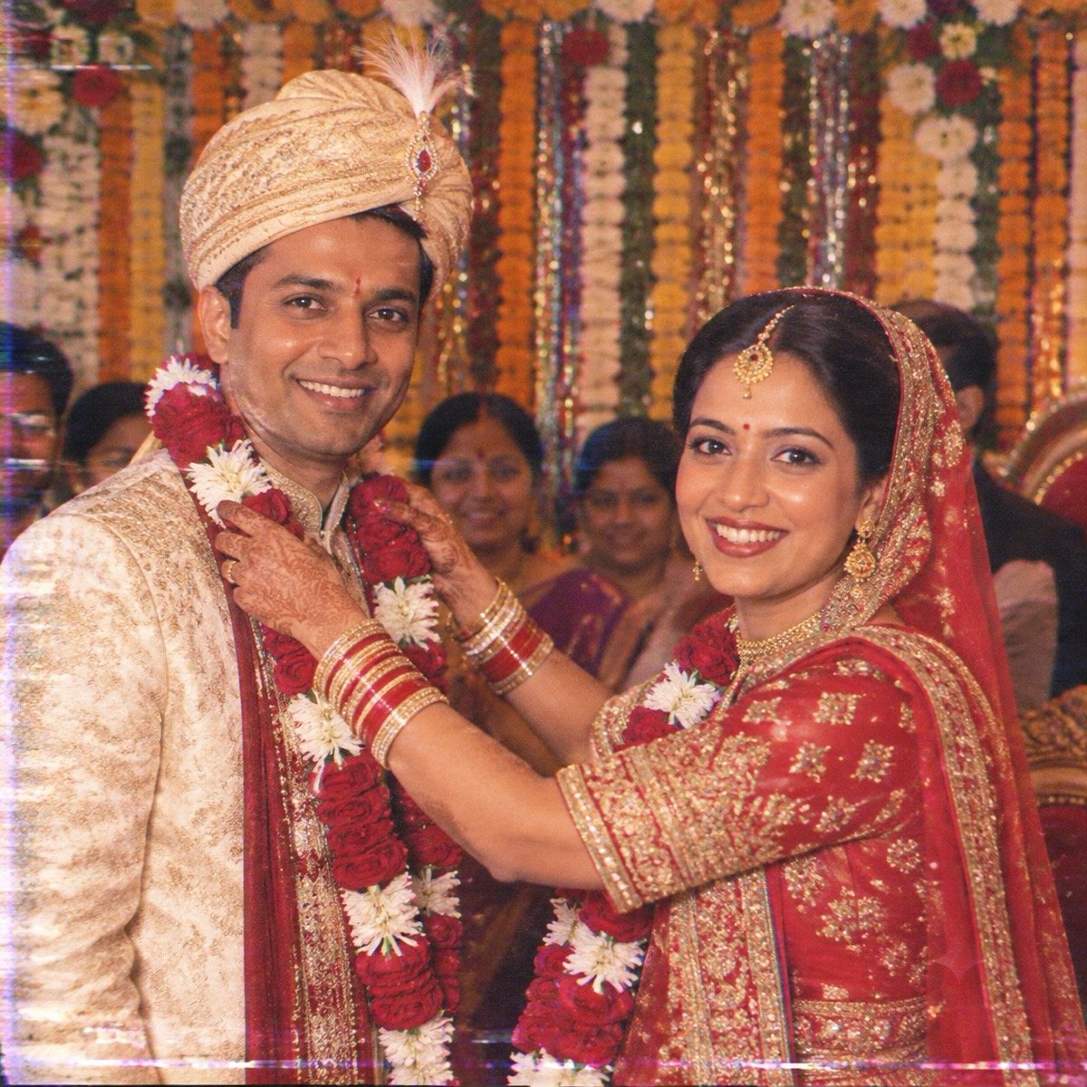ChatGPT result for prompt 4: a bride placing a garland on the groom in a faded 1990s wedding-video frame