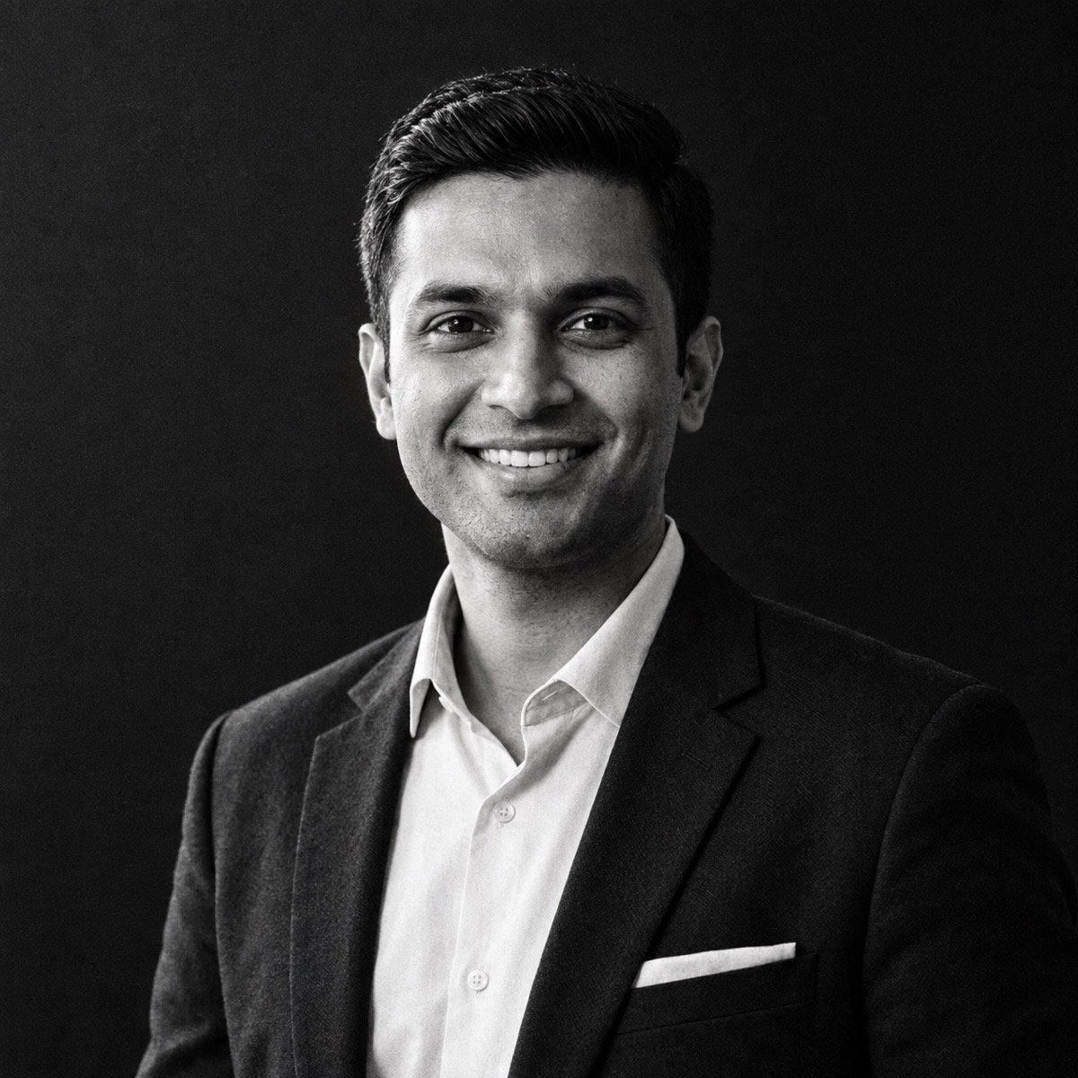 ChatGPT result for prompt 11: a black-and-white editorial portrait of a man lit from one side against a dark background